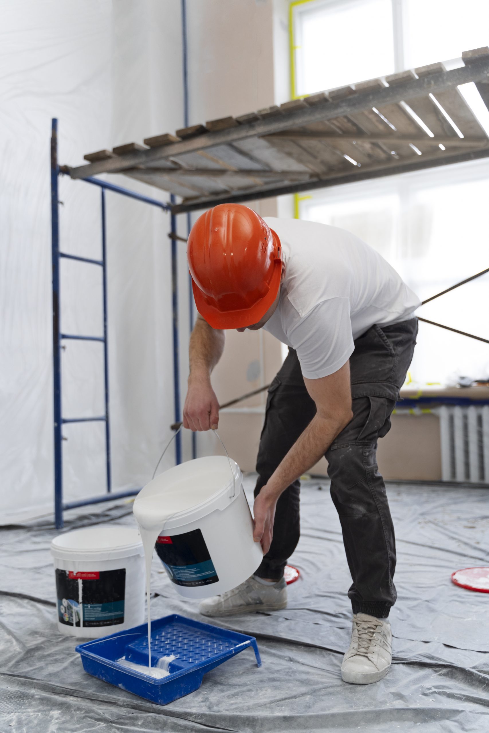 full shot man pouring paint