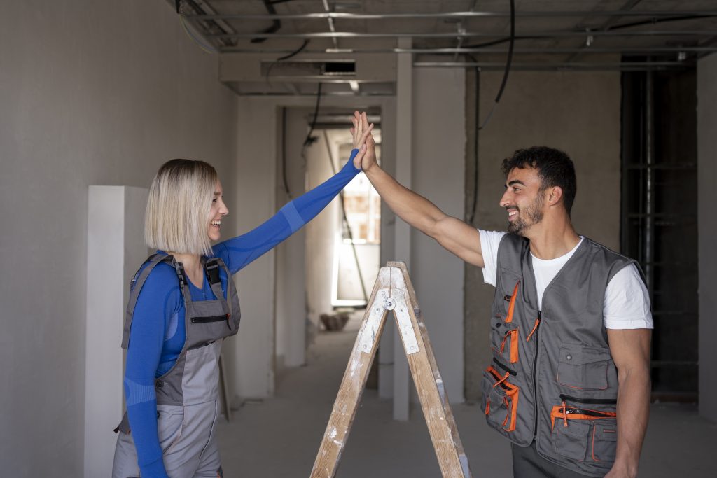 medium shot workers high five